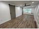 Open room featuring new flooring, fresh paint, a ceiling fan, and sliding barn doors at 1130 W Lake Brantley Rd, Altamonte Springs, FL 32714