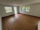 Bright living room with large windows and wood-look flooring offers a welcoming space at 1130 W Lake Brantley Rd, Altamonte Springs, FL 32714