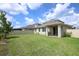 Spacious backyard featuring lush lawn, privacy fence, and covered patio at 1222 Castlevecchio Loop, Orlando, FL 32825
