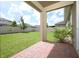 Enjoy the serene view of the private, fenced backyard from the covered patio at 1222 Castlevecchio Loop, Orlando, FL 32825