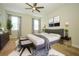 A styled primary bedroom featuring a ceiling fan, rug, and ample natural light at 1222 Castlevecchio Loop, Orlando, FL 32825