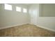 Bedroom with neutral carpet, base molding, and three windows at 1222 Castlevecchio Loop, Orlando, FL 32825