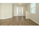Spacious foyer with natural light, wood flooring, and a view of the front door and window at 1222 Castlevecchio Loop, Orlando, FL 32825