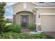 Inviting front entrance featuring a brick path, tasteful landscaping, and a covered porch with stone accents at 1222 Castlevecchio Loop, Orlando, FL 32825