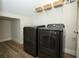 An organized laundry room with modern washer and dryer, wire shelving, and wood-look tile at 1222 Castlevecchio Loop, Orlando, FL 32825