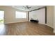 Spacious living room with wood floors, modern accent wall, ceiling fan, and sliding glass door at 1222 Castlevecchio Loop, Orlando, FL 32825