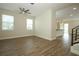 Spacious living room with wood floors, natural light, and a partial view into the kitchen at 1222 Castlevecchio Loop, Orlando, FL 32825