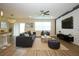 Cozy living room featuring a modern sofa, textured wall, ceiling fan, and stylish decor at 1222 Castlevecchio Loop, Orlando, FL 32825