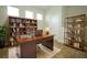 Home office with wooden desk and bookshelves filled with books at 1222 Castlevecchio Loop, Orlando, FL 32825