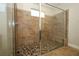 Modern tiled shower with a glass door and pebble base at 1222 Castlevecchio Loop, Orlando, FL 32825