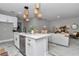 Open-concept kitchen with white cabinets, stainless steel appliances, and an island with seating at 12260 Sw 56 Ln, Ocala, FL 34481