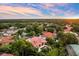 Aerial view showcasing a home with a private pool surrounded by lush greenery at 1274 Prince Ct, Lake Mary, FL 32746