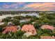 A stunning aerial view of the tile roof home with lush tropical landscaping and tranquil lake views at 1274 Prince Ct, Lake Mary, FL 32746