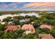 Gorgeous aerial view of tile roof home and verdant landscape, near lake, providing a serene, upscale living at 1274 Prince Ct, Lake Mary, FL 32746