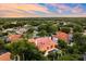 Beautiful aerial view of a tile roofed home with pool nestled within a lush landscape during sunset at 1274 Prince Ct, Lake Mary, FL 32746