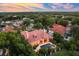 Beautiful aerial view of tile roof home, pool, and lush landscape offering privacy and elegant living at 1274 Prince Ct, Lake Mary, FL 32746