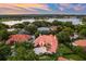 A beautiful aerial view of the tile roof home and lush tropical landscaping, showcasing a tranquil lake view at 1274 Prince Ct, Lake Mary, FL 32746