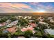 Beautiful aerial view of a tile roofed home nestled within a lush landscape with a pond nearby at 1274 Prince Ct, Lake Mary, FL 32746