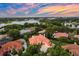 A stunning aerial view of the tile roof home, meticulously landscaped gardens, and inviting pool at 1274 Prince Ct, Lake Mary, FL 32746
