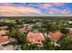 A captivating aerial view of the tile roofed home, showcasing its meticulously manicured landscape and pool at 1274 Prince Ct, Lake Mary, FL 32746
