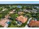 Wonderful aerial view showcasing a pool and homes with tile roofs nestled within a lush, green landscape at 1274 Prince Ct, Lake Mary, FL 32746