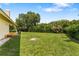 Expansive backyard with lush green lawn and mature trees, perfect for outdoor activities at 1274 Prince Ct, Lake Mary, FL 32746