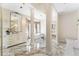 Expansive bathroom with marble floors, columns, dual sinks, soaking tub, and bedroom access at 1274 Prince Ct, Lake Mary, FL 32746