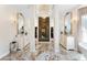 Grand bathroom with marble floors, dual vanities, large mirrors, and walk-in closets at 1274 Prince Ct, Lake Mary, FL 32746