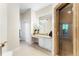 Elegant bathroom with dual sinks, marble countertops, a walk-in shower, and a separate toilet room at 1274 Prince Ct, Lake Mary, FL 32746