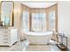 Luxurious bathroom boasting a large tub, elegant fixtures, and marble flooring at 1274 Prince Ct, Lake Mary, FL 32746