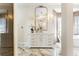 Upscale bathroom featuring a marble vanity, ornate mirror, and an elegant chandelier at 1274 Prince Ct, Lake Mary, FL 32746