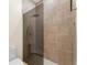 Sleek glass-enclosed shower features a geometric tile pattern and modern fixtures for a spa-like experience at 1274 Prince Ct, Lake Mary, FL 32746