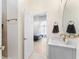 Modern bathroom with marble vanity, gold fixtures and an open door to a bedroom with natural light at 1274 Prince Ct, Lake Mary, FL 32746