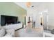 Neutral toned Bedroom with sage accent wall, stylish modern furniture, and bright lighting at 1274 Prince Ct, Lake Mary, FL 32746