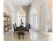 Elegant dining room with stylish chairs, chandelier, and floor to ceiling windows at 1274 Prince Ct, Lake Mary, FL 32746
