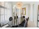 A grand dining room with tall columns, an elegant chandelier, and a large dark dining table at 1274 Prince Ct, Lake Mary, FL 32746
