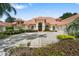 Gorgeous exterior highlighting the terracotta roof, elegant entry, and circular driveway at 1274 Prince Ct, Lake Mary, FL 32746