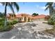 Beautiful exterior with a well-maintained lawn, palm trees, terracotta roof, and circular driveway at 1274 Prince Ct, Lake Mary, FL 32746