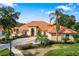 Lovely single-Gathering home featuring a circular driveway, terracotta roof and lush, green landscaping at 1274 Prince Ct, Lake Mary, FL 32746