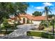 Elegant home with a terracotta tile roof, circular driveway and well manicured landscaping at 1274 Prince Ct, Lake Mary, FL 32746