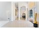 Open foyer with a decorative mirror, archways, and a view of the dining room at 1274 Prince Ct, Lake Mary, FL 32746