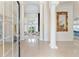 Bright, spacious foyer with tall windows, white columns, and decorative gold mirror at 1274 Prince Ct, Lake Mary, FL 32746