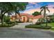 Charming home features a circular driveway and a tile roof surrounded by manicured landscaping at 1274 Prince Ct, Lake Mary, FL 32746
