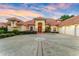 Stunning home featuring a circular driveway and a tile roof, set against a vibrant sunset at 1274 Prince Ct, Lake Mary, FL 32746