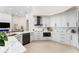 Elegant kitchen featuring white cabinetry, marble backsplash, stainless steel appliances, and an island at 1274 Prince Ct, Lake Mary, FL 32746