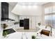 Well-lit kitchen with white cabinets, marble countertops, and stainless steel appliances at 1274 Prince Ct, Lake Mary, FL 32746