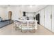 Bright kitchen with white cabinets, marble countertops, island with seating, and black appliances at 1274 Prince Ct, Lake Mary, FL 32746