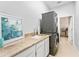 Functional laundry room with granite counters, sink, modern washer, and dryer, offering convenience and style at 1274 Prince Ct, Lake Mary, FL 32746