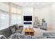 Bright and airy living room with a gray sectional sofa and a fireplace at 1274 Prince Ct, Lake Mary, FL 32746