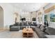 Open-concept living room with a large sectional, seamlessly connected to a modern kitchen at 1274 Prince Ct, Lake Mary, FL 32746